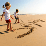 Children writing in the sand