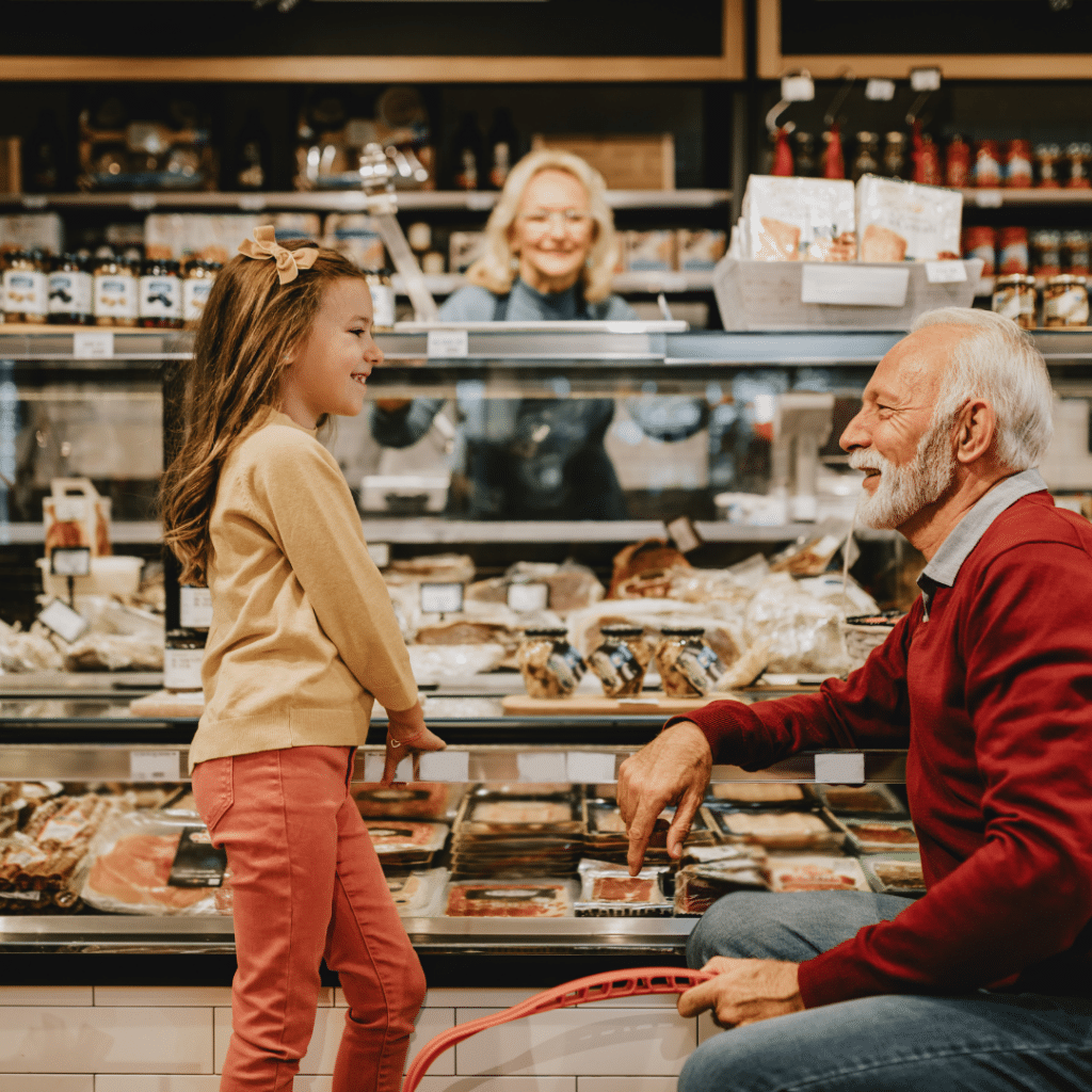 Child grocery shopping with grandparent