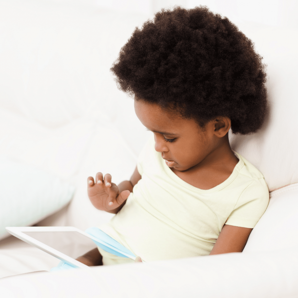 toddler playing on tablet.