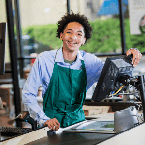 A cashier smiling