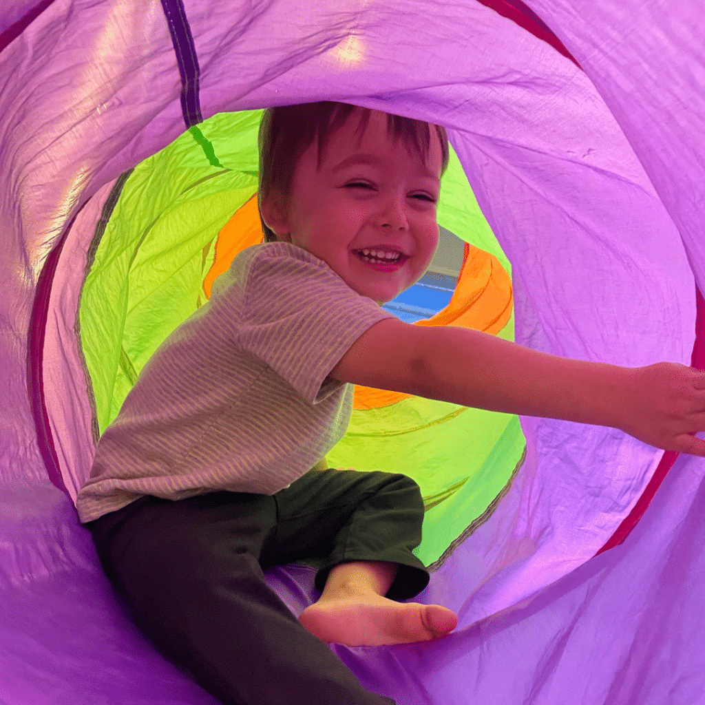 child in play tunnel