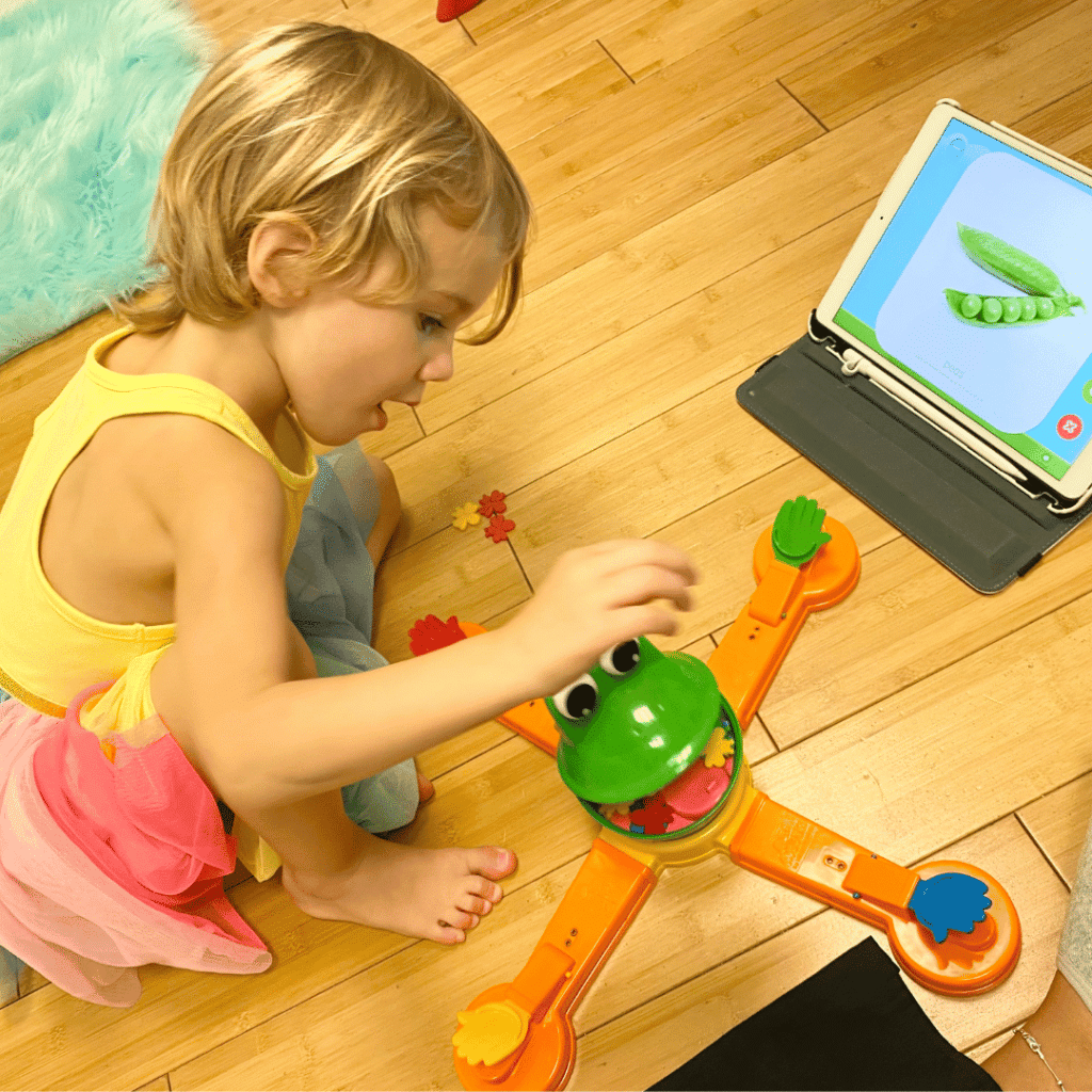 child playing with frog game