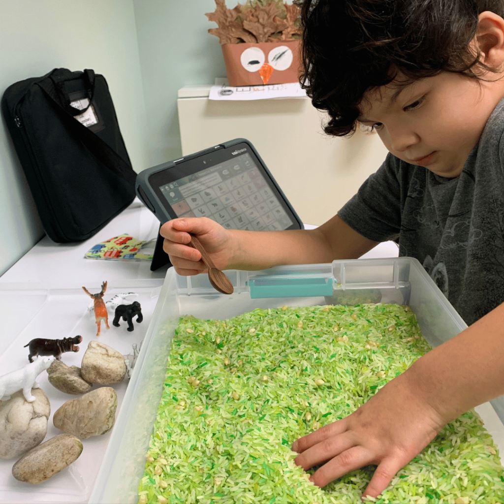 child playing with rice sensory bin