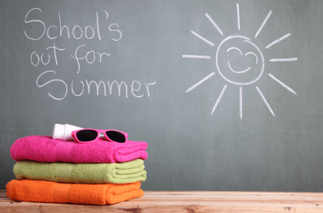 Schools out for summer written on chalk board