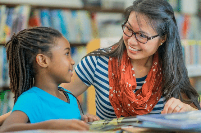 Child and teacher reading